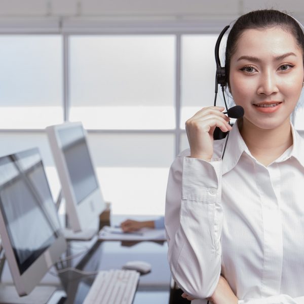 Portrait Asian women business office call center operator. Helpdesk support phone call team worker female teen smile with microphone headset.telesale marketing agant people.